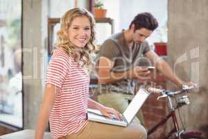 Portrait of businesswoman with laptop in office