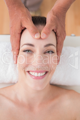 Smiling woman receiving head massage