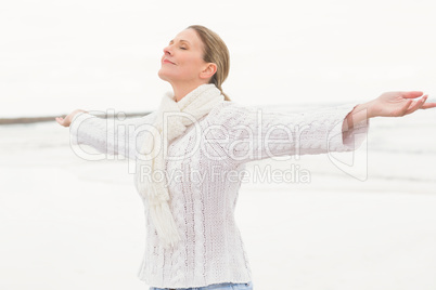 Woman standing with arms open wide