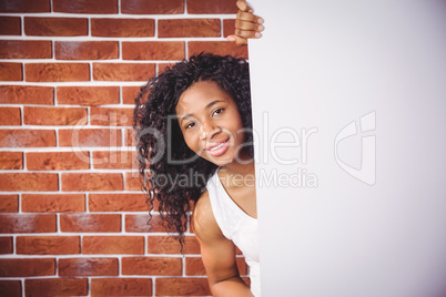 Smiling woman holding white board