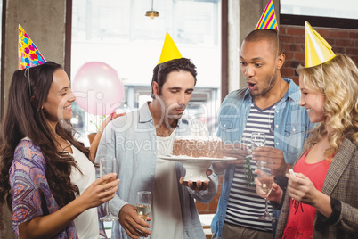Man blowing candle on cake at celebration