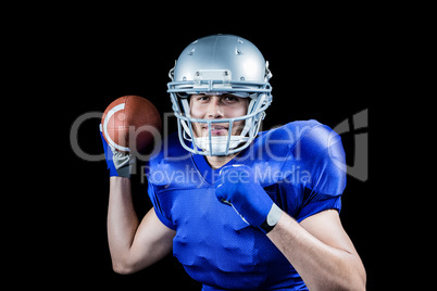 Portrait of sportsman smiling while throwing ball