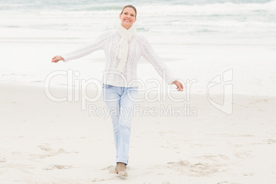 Woman standing with arms open wide