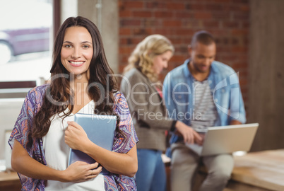 Portrait of smiling woman holding digital tablet Portrait of smiling woman holding digital tablet