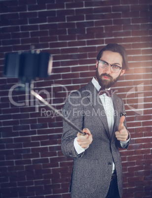 Confident man taking selfie through smartphone