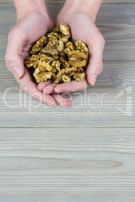 Woman showing handful of walnuts