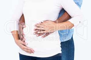 Couple hands on belly against white background
