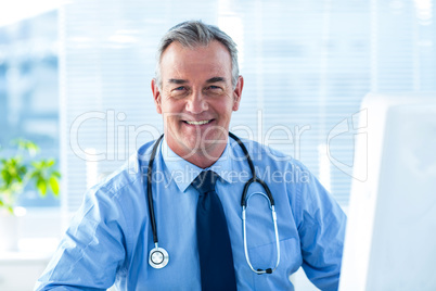 Portrait of smiling male doctor in hospital