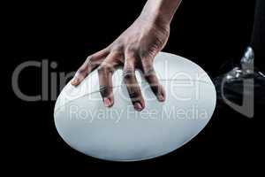 Cropped image of sportsman holding rugby ball