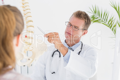 Doctor showing his patient a spine model