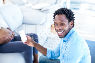 Portrait of happy man holding smartphone