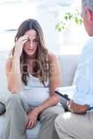 psychiatrist advising pregenat woman in clinic