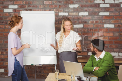 Businesswoman briefing colleagues in office