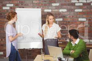 Businesswoman briefing colleagues in office