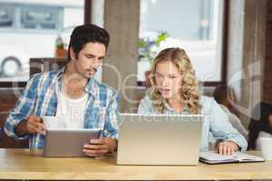 Business people looking at laptop