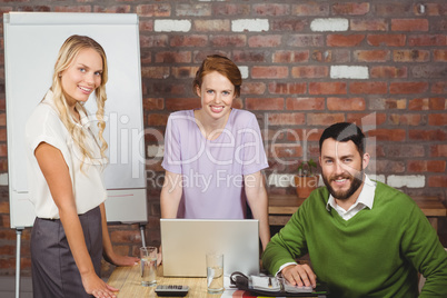 Portrait of happy business people smiling during discussion in o Portrait of happy business people smiling during discussion in o