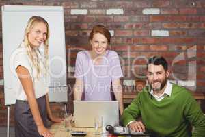 Portrait of happy business people smiling during discussion in o