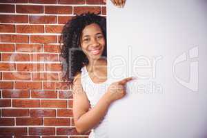 Smiling woman pointing to white board