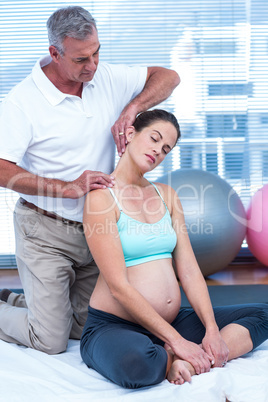 Pregnant woman in gym with trainer