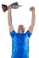 Happy rugby player holding trophy