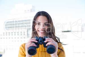 Pretty woman looking through binoculars