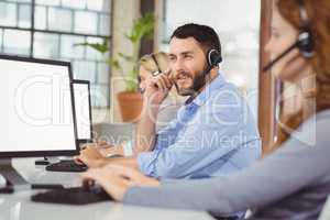 Thoughtful man working while sitting in office