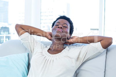 Woman relaxing on sofa at home