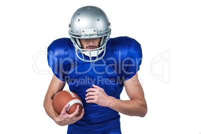 Sports player wearing helmet while holding ball