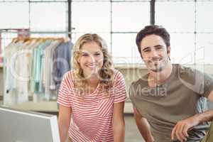 Portrait of smiling fashion designers in office