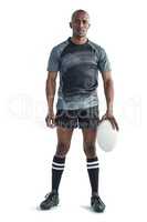 Portrait of sportsman holding rugby ball while standing