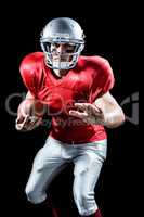 Portrait of defensive sportsman holding American football