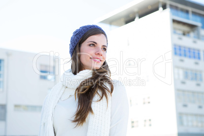 Brunette with warm clothes looking away