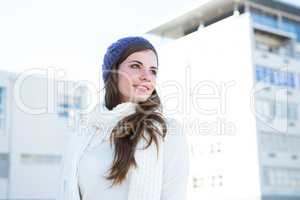 Brunette with warm clothes looking away
