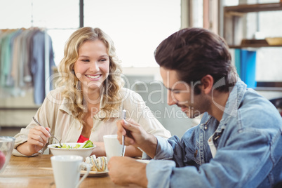 Woman having breakfast with colleague in office