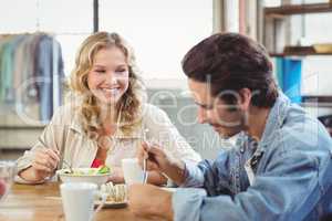 Woman having breakfast with colleague in office