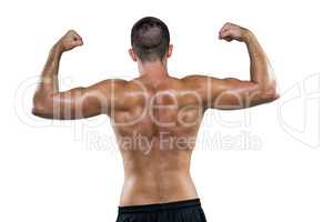 Rear view of shirtless athlete flexing muscles