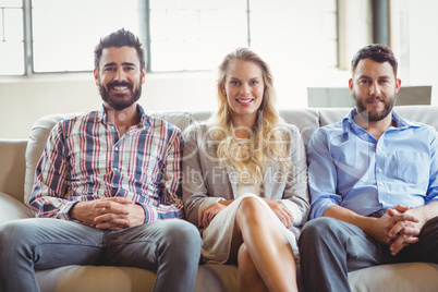 Portrait of happy business people sitting on sofa