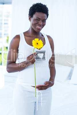 Portrait of smiling woman touching her belly