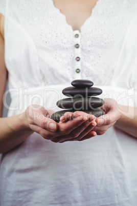 Woman holding black stones