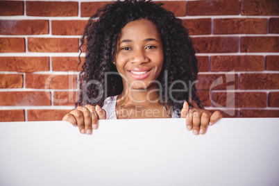 Smiling woman holding white board