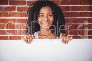Smiling woman holding white board