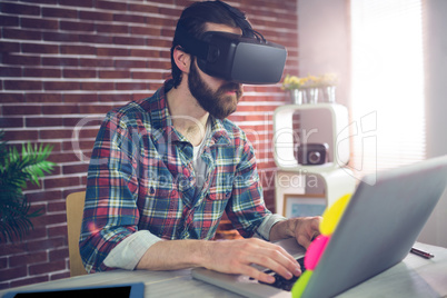 Creative businessman wearing 3D video glasses at office