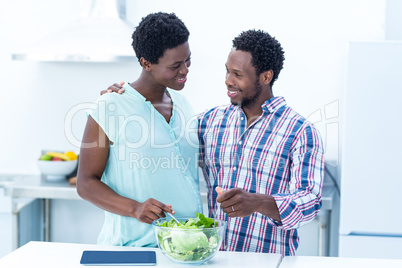 Couple looking at each other while having salad