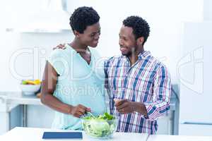 Couple looking at each other while having salad