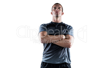 Confident rugby player with arms crossed