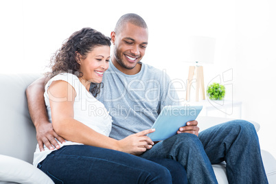 Young couple looking at tablet computer