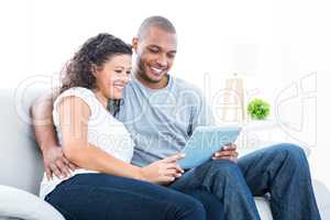 Young couple looking at tablet computer