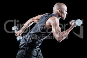 Muscular man running while holding dumbbell