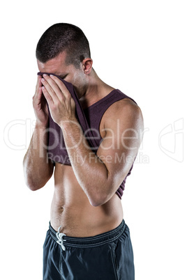 An athlete wiping sweat off his face