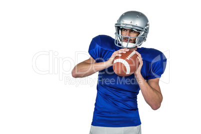 American football player holding ball white looking away